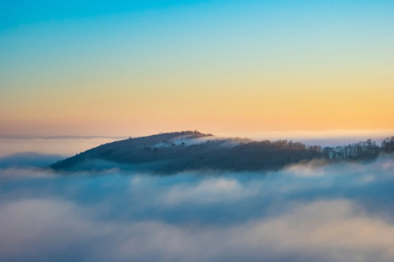 an island in the clouds and a bright sunset