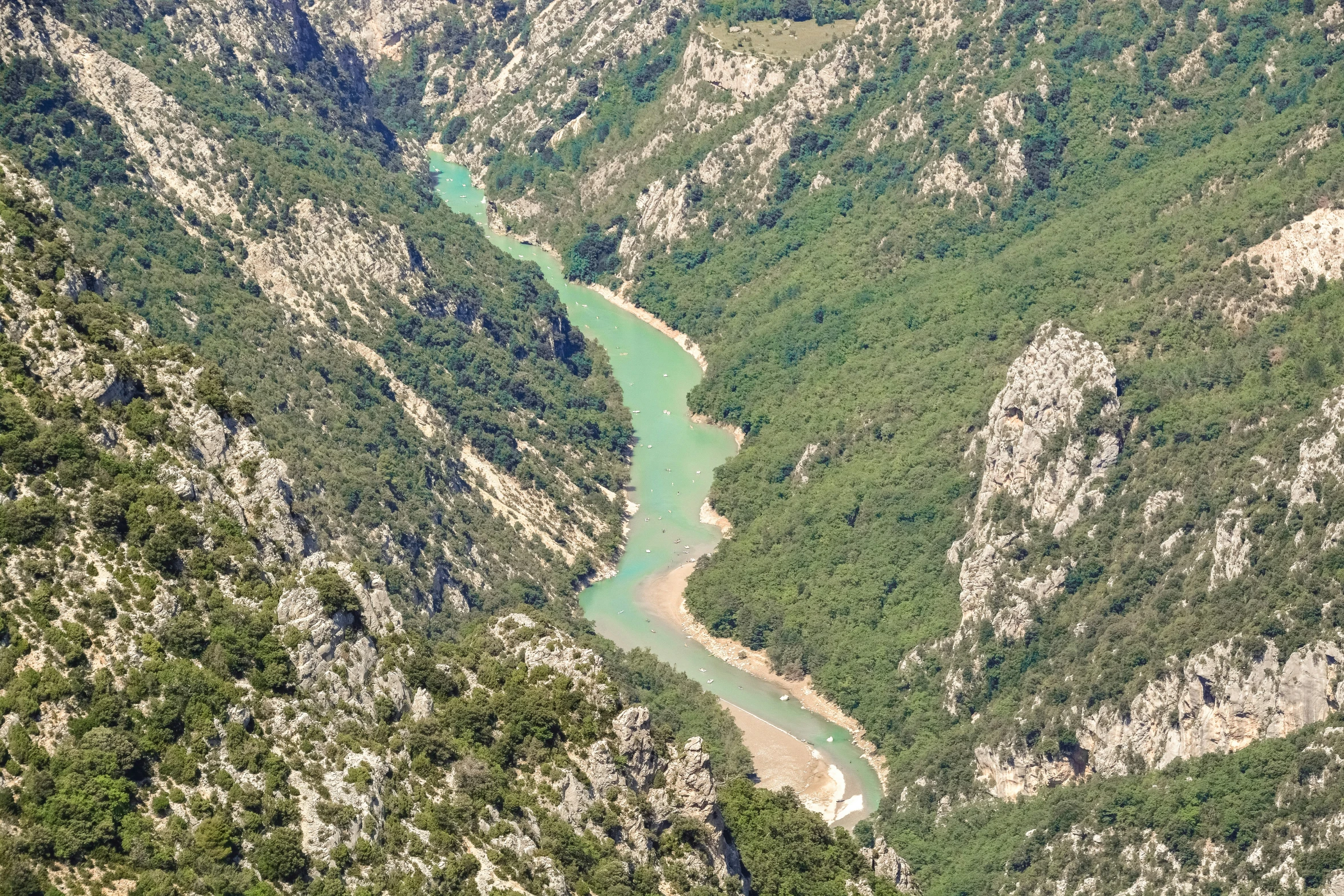 a river runs through the woods of a valley