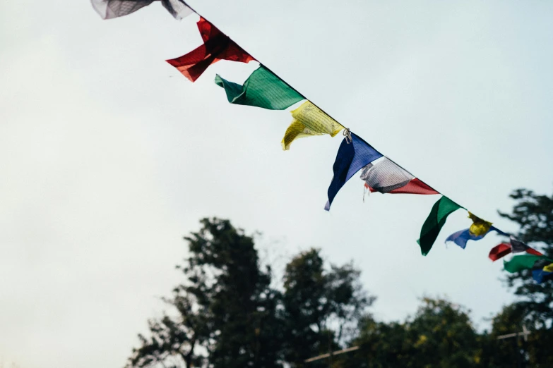 a bunch of colorful flags on a line