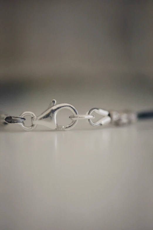 the silver ring on top of a white table