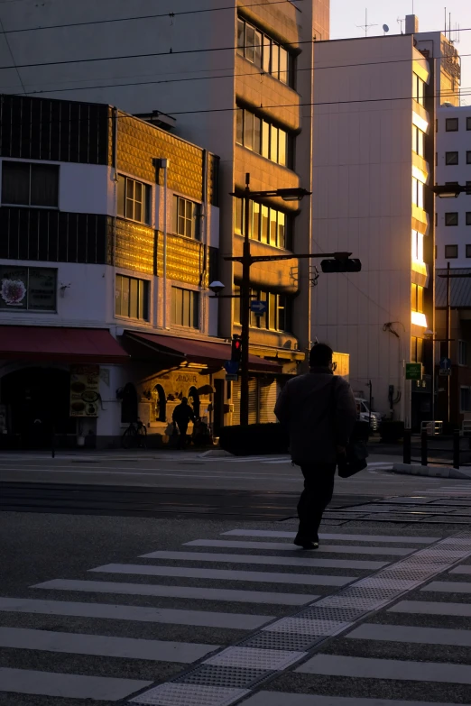 the back light of a tall building is shining on the pedestrians