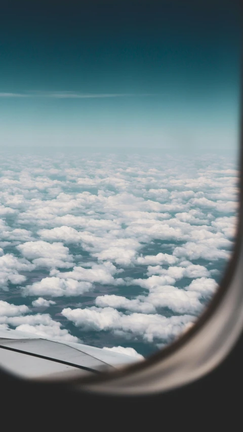 view through the window of an airplane with the wing visible