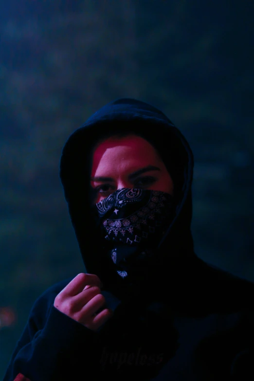 a person with a hood and mask covering their face