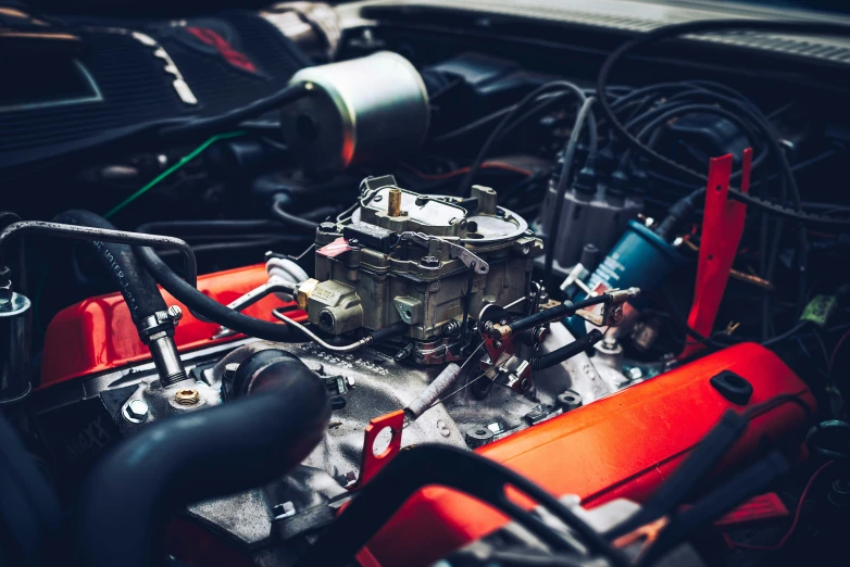 the engine bay of an orange sports car