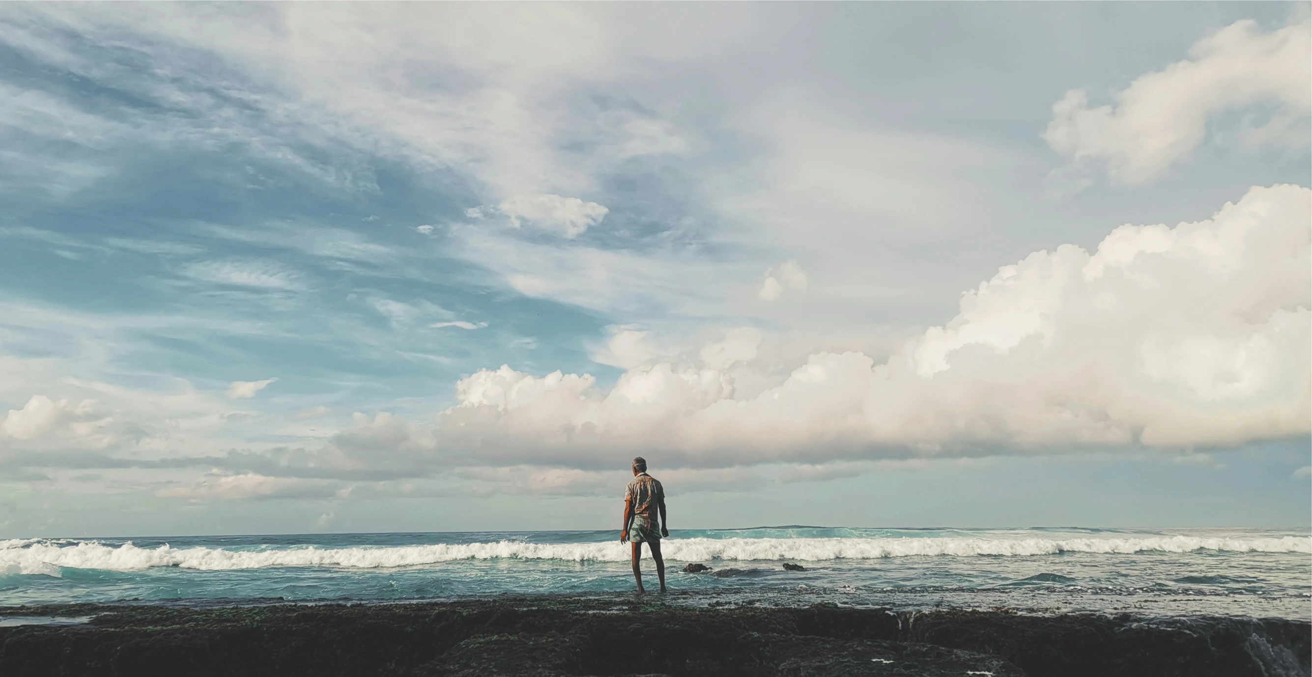 there is a person standing in the water holding a surfboard