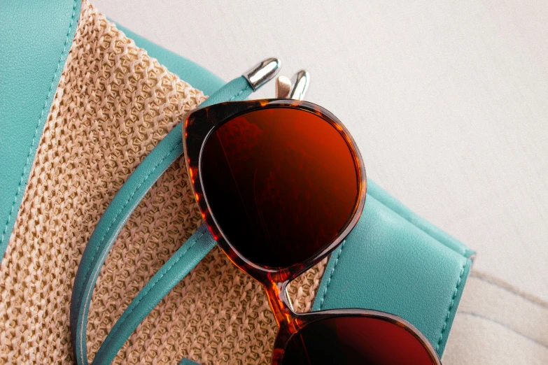 a pair of sunglasses resting on top of a beach towel