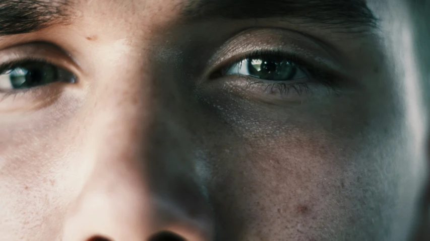 a man's green eyes, close - up of his eye