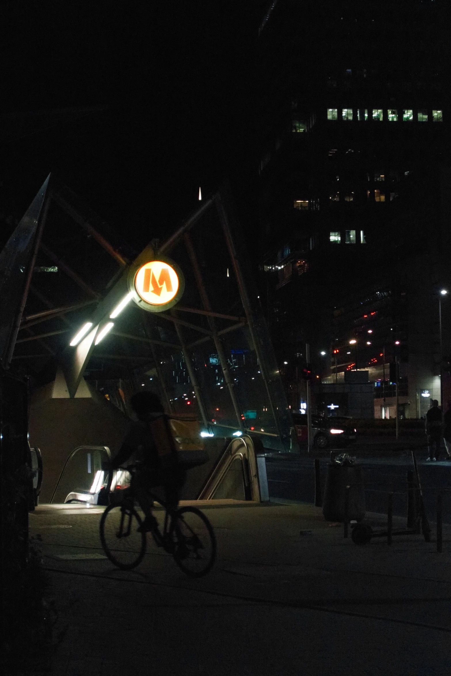 a bike rider on a path lit up at night