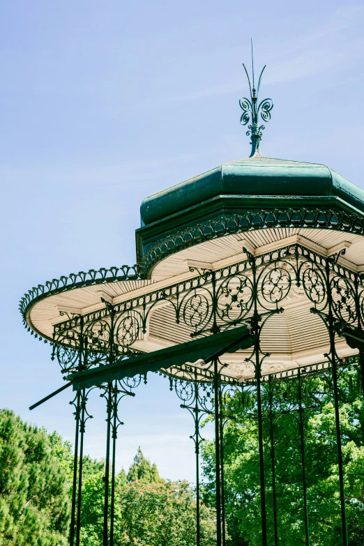 the canopy of a gazebo sits in a park