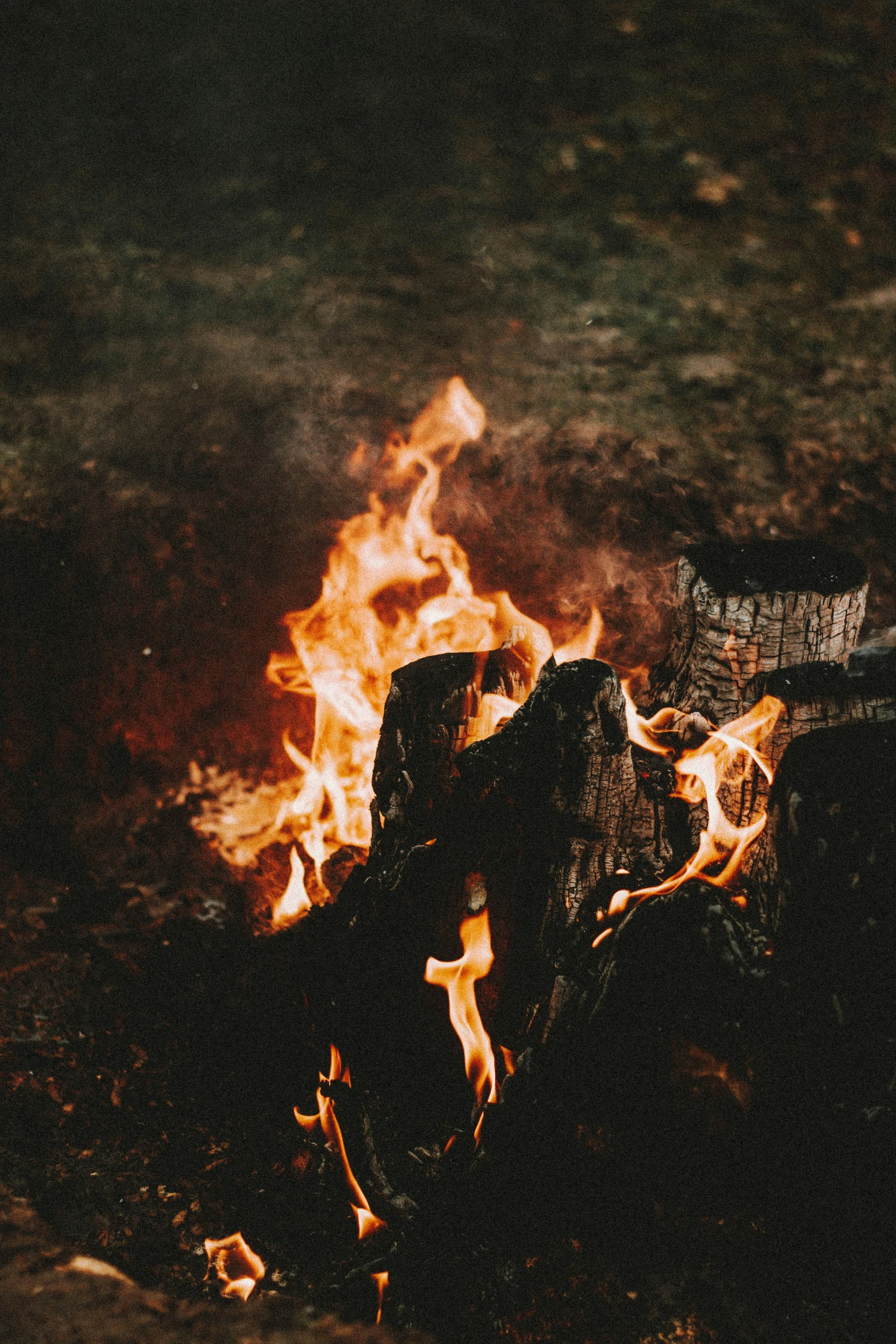 a pile of logs in flames in the dark