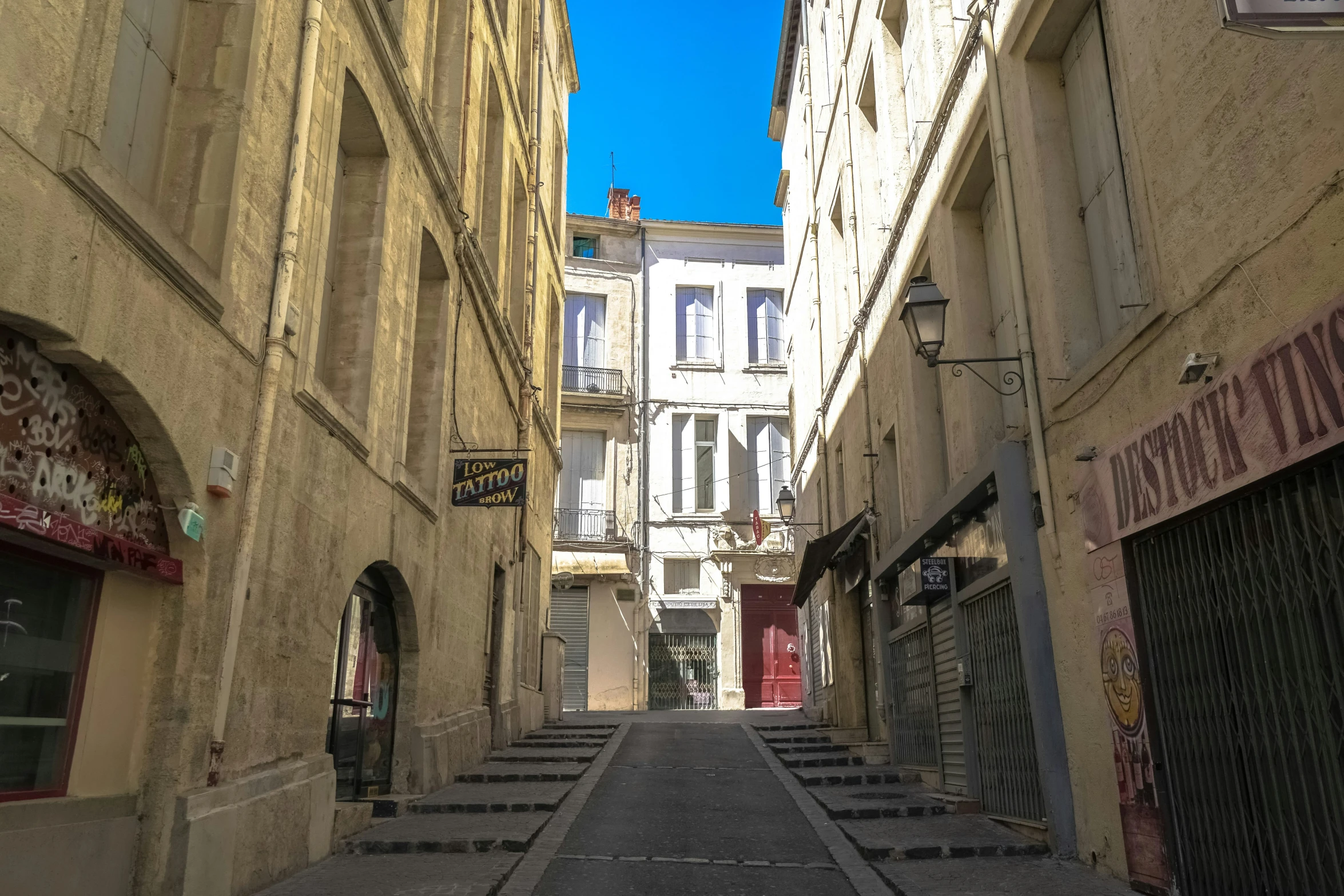 the narrow alleyway of a city has been constructed into many smaller buildings