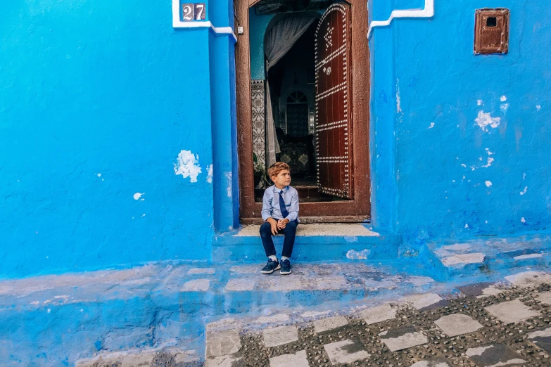 a child standing on the outside of a door