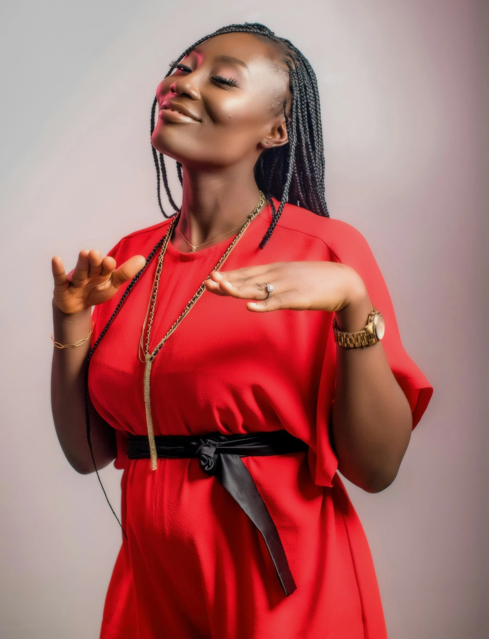 a woman in a red dress poses for the camera