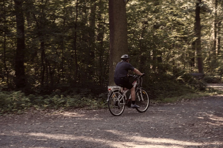 a person riding their bike on a wooded trail