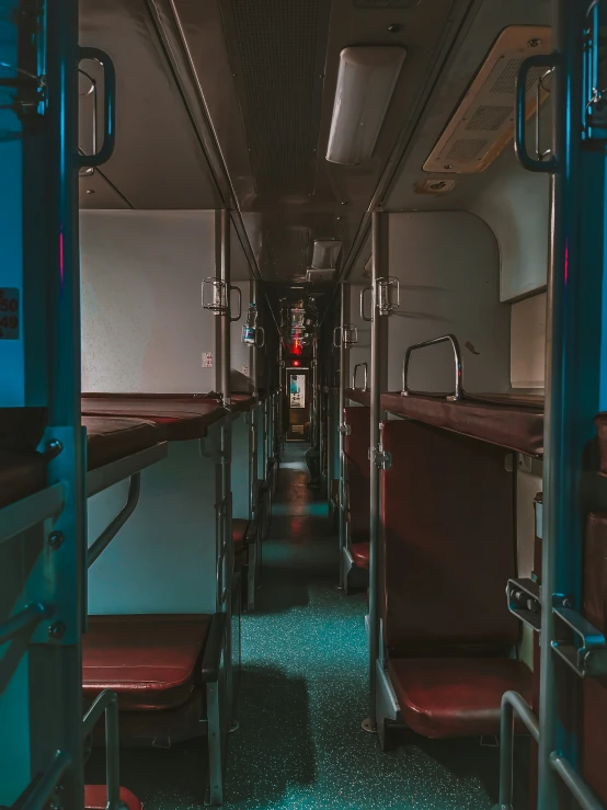 a long aisle lined with empty seats and a wall