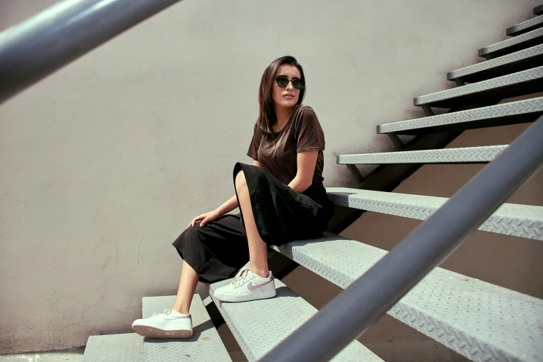 a young woman sitting on steps on a building