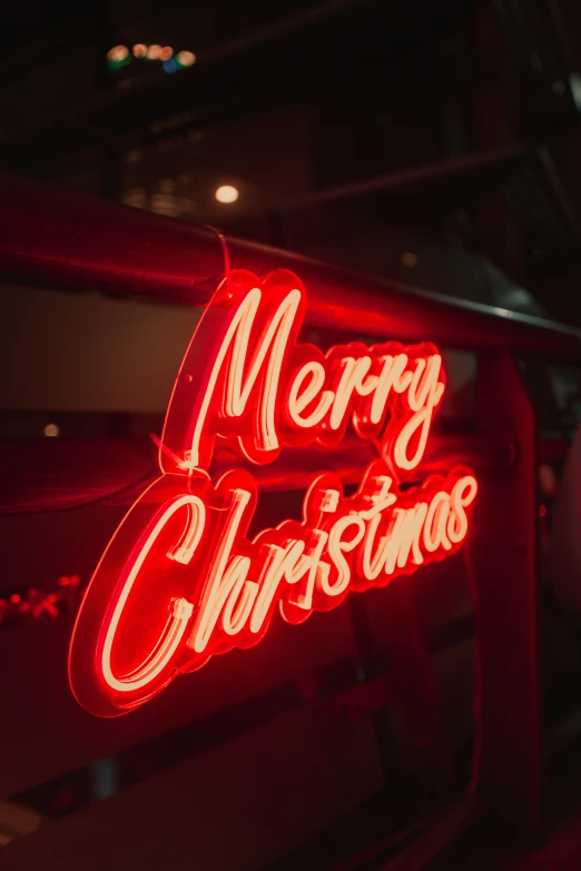 the merry christmas sign is lit up for the camera