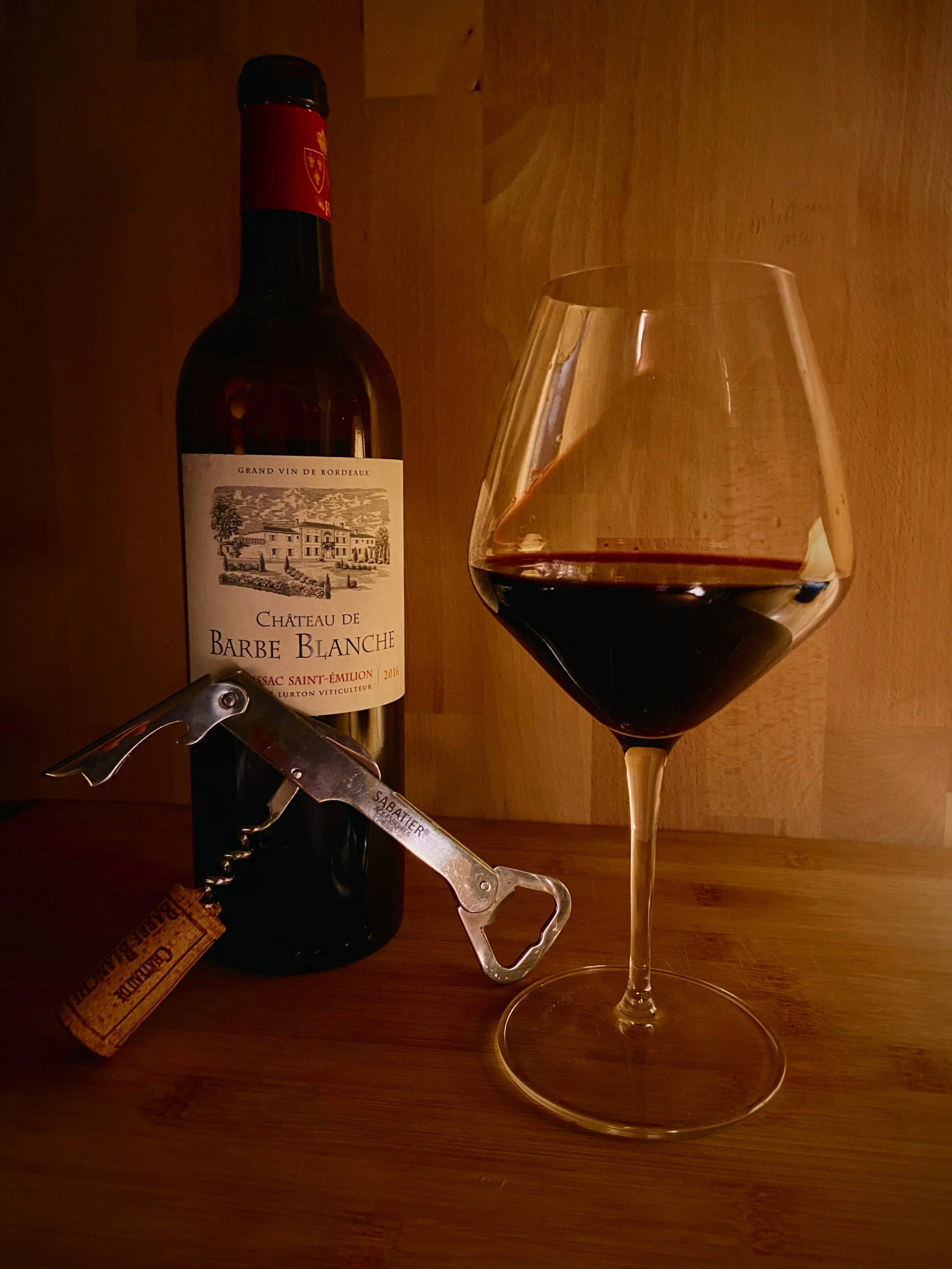 an image of a bottle and glass with wine
