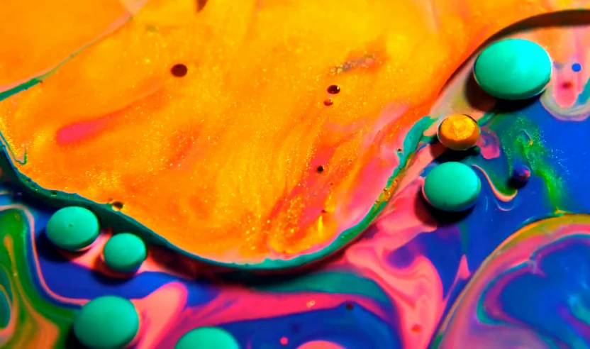 colored and fluid paint mixing together in colors