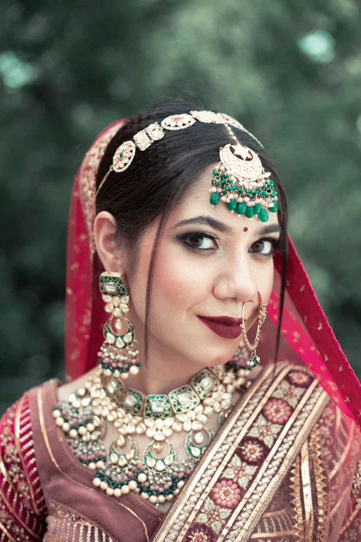 indian woman dressed in traditional bridal outfit and jewelry