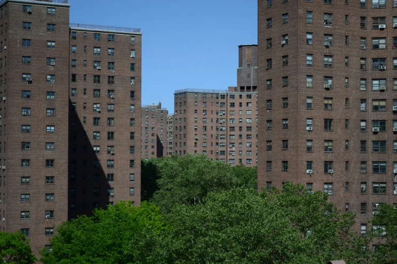 a red fire hydrant is next to tall brown buildings