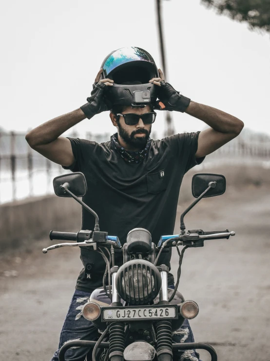 a man riding on the back of a motorcycle wearing a helmet