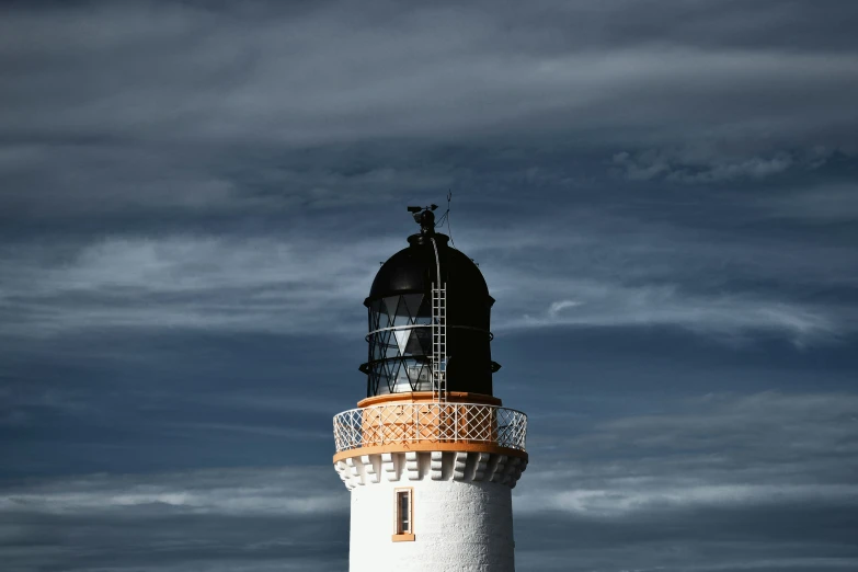 the lighthouse is white and brown with a clock