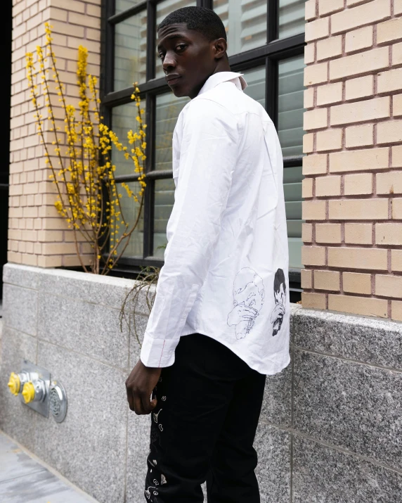 a person with a long white shirt and black pants