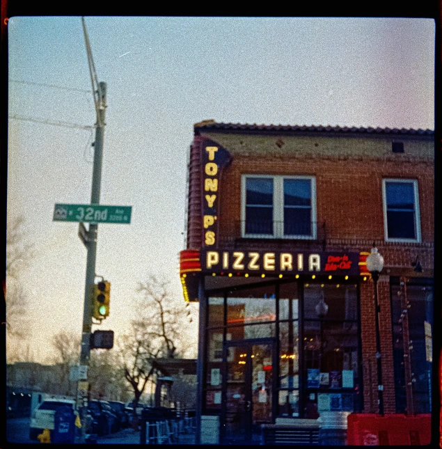 a pizza store with lots of signs next to the building