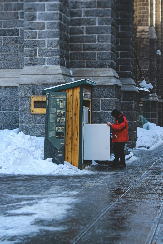 the man in red is looking into the freezer