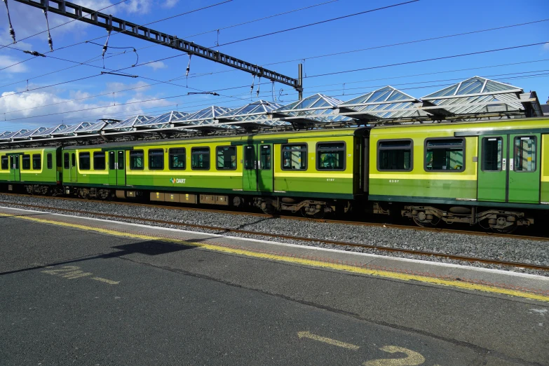 a train on a train track in front of buildings