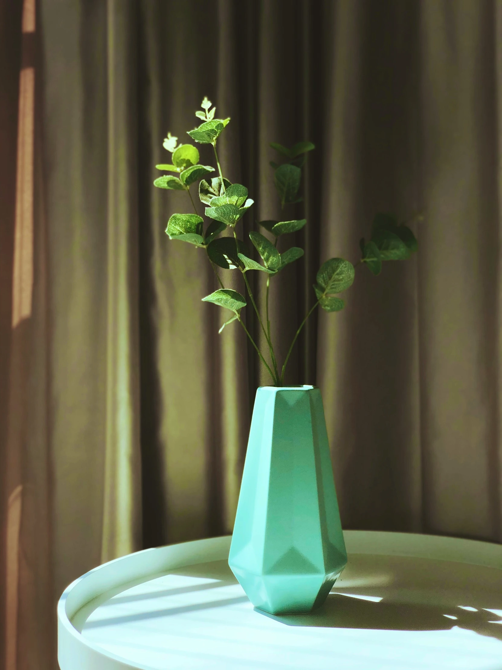 a flower in a blue vase on a table