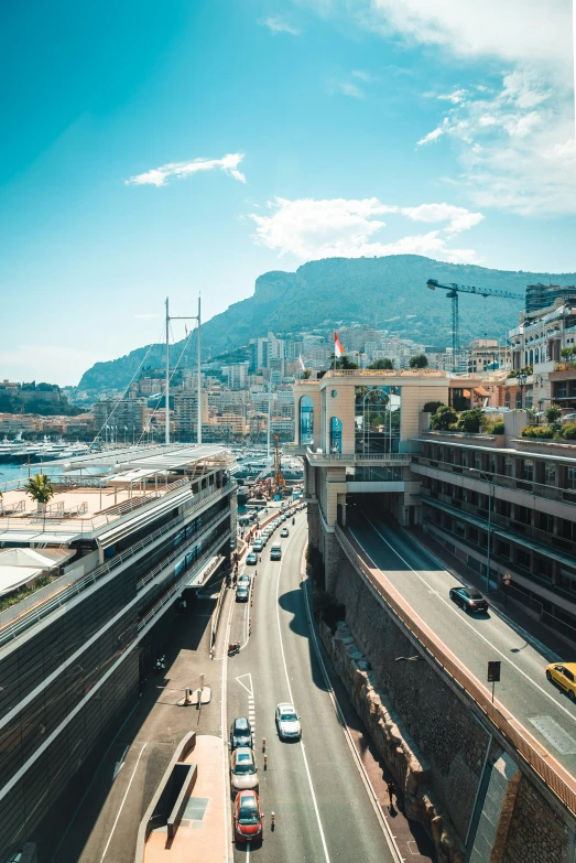 a view from a high point of view shows the ocean, buildings and cars