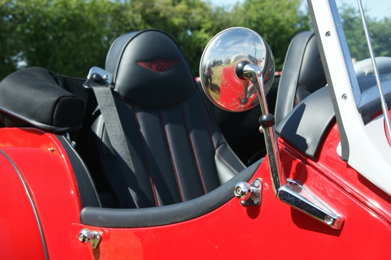 a car is shown with red and black leather seats