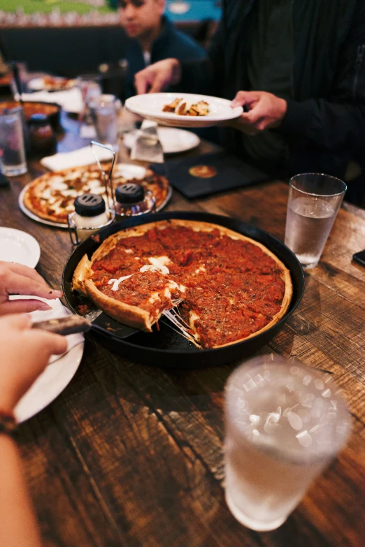 several pizza pies are sitting on the table