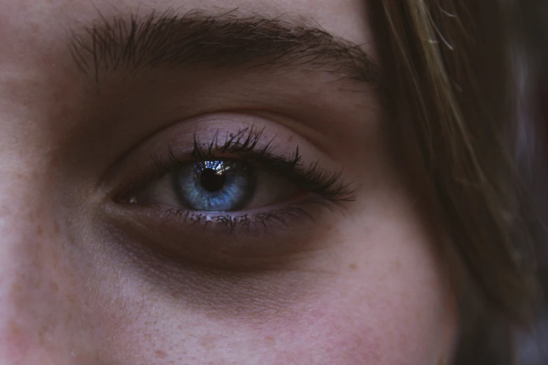 a close up of an eye with a tooth brush in the middle