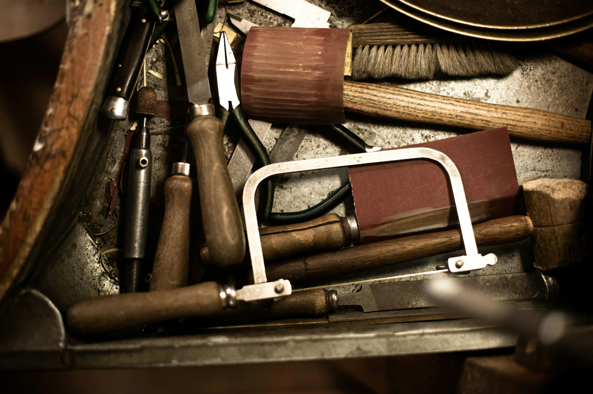 a variety of various tools are piled on a shelf