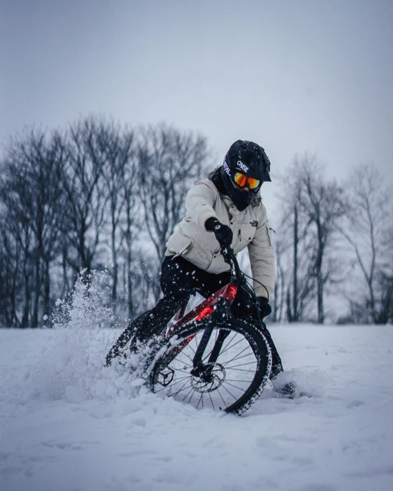 a person riding a bike in the snow