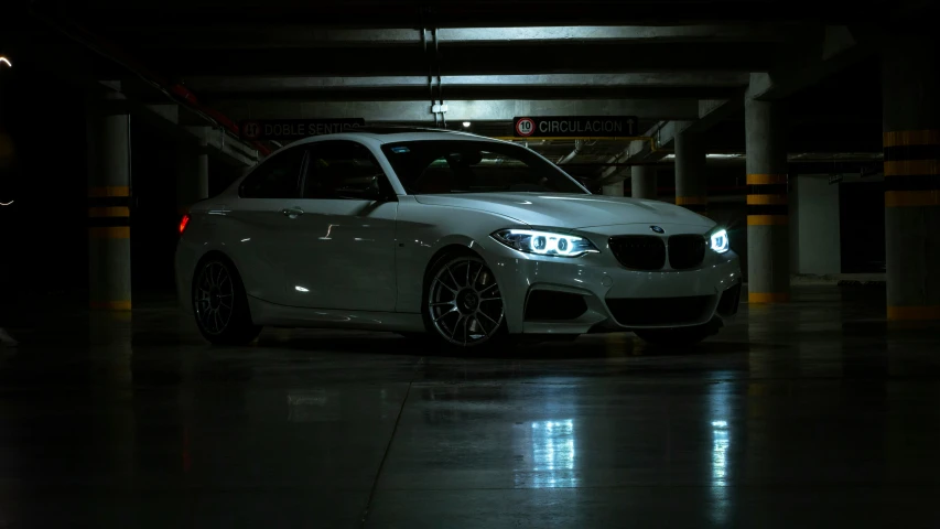 a white car that is parked in a parking garage