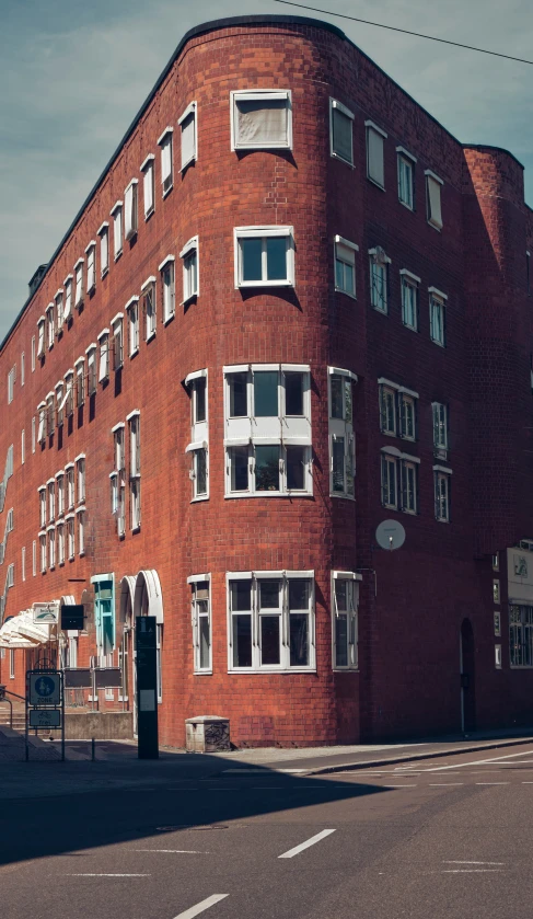 an old, tall red brick building has lots of windows