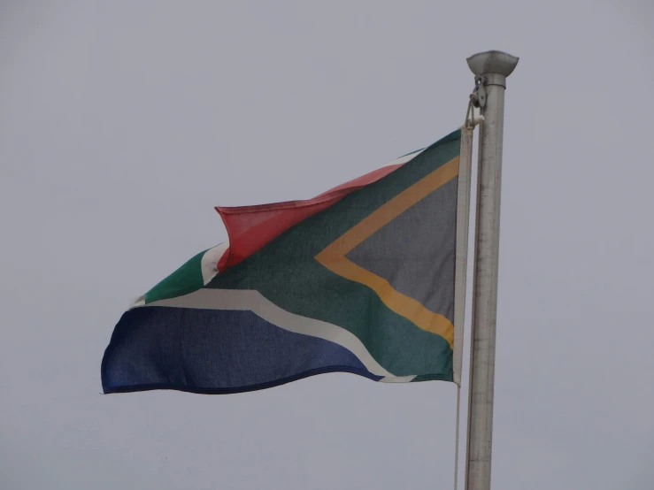 the national flag flies above a wind turbine