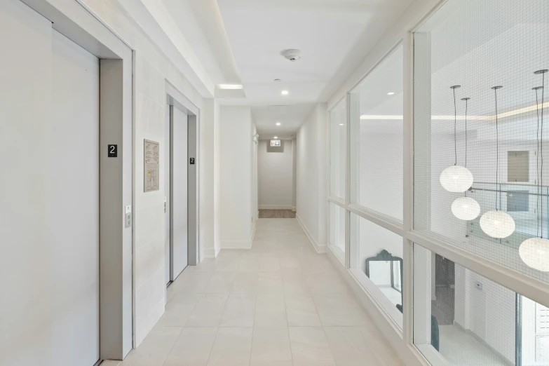 empty long hallway with a variety of doors leading to different rooms