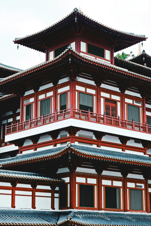 tall red and white building with red railings