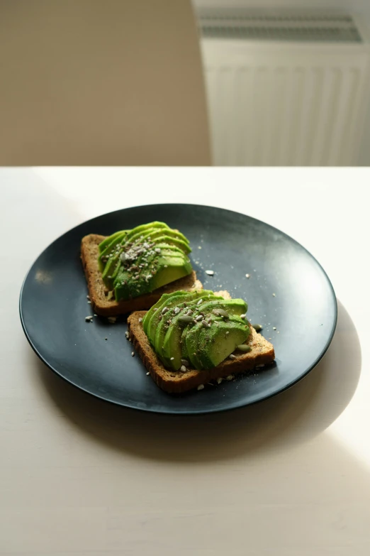 two slices of bread are covered in green toppings