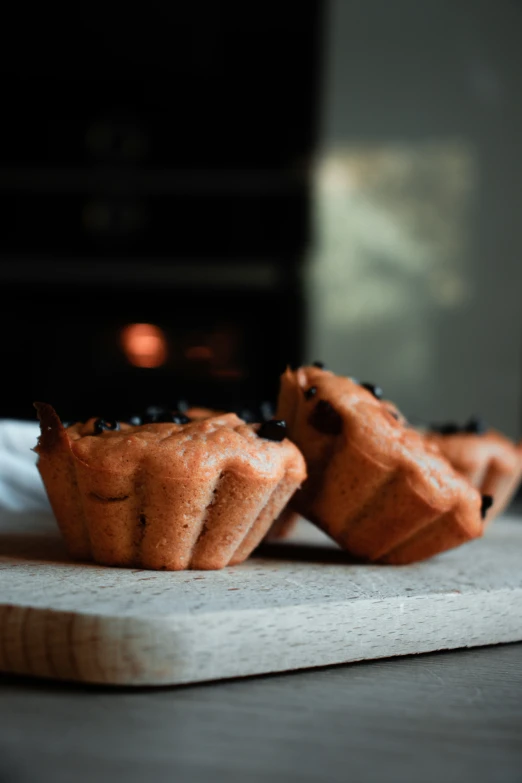 two baked pastries that are sitting on top of a  board