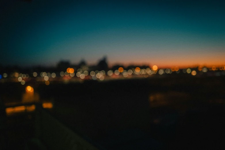 the city lights are seen from the side of the car