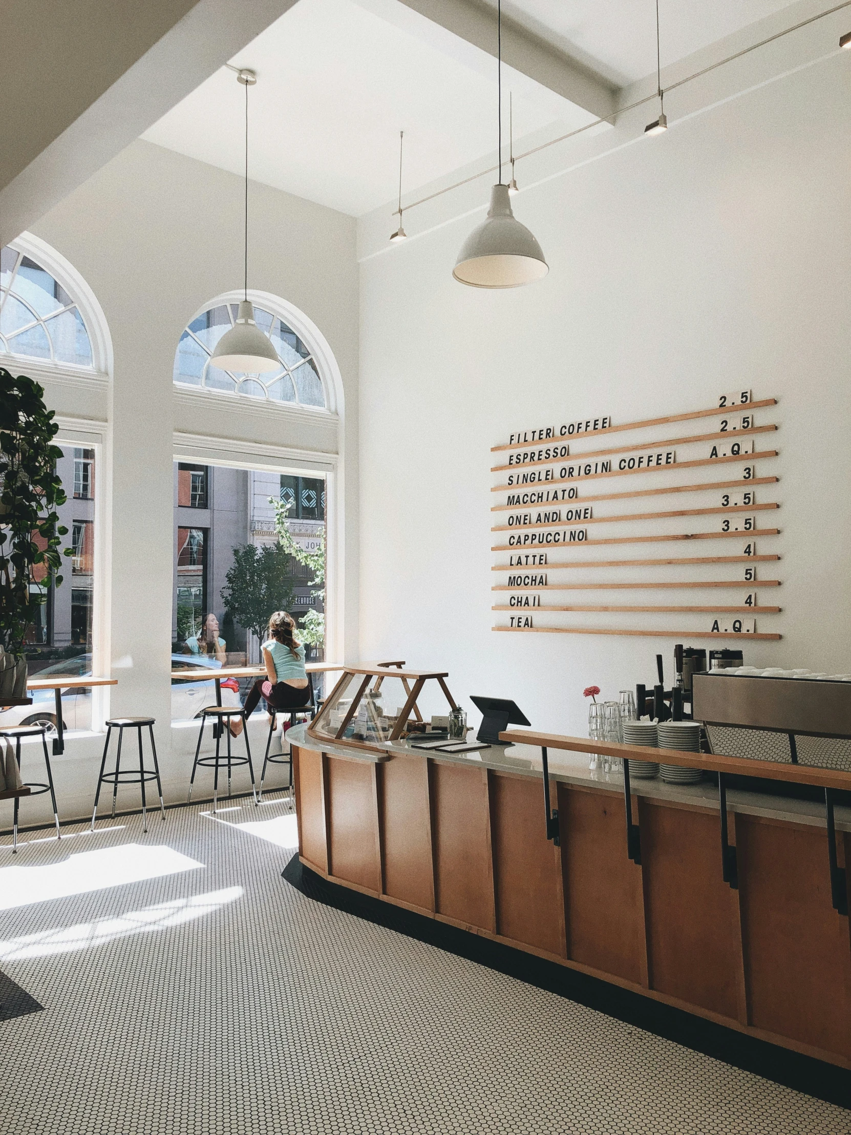 a large window opens into a well - lit cafeteria and bar