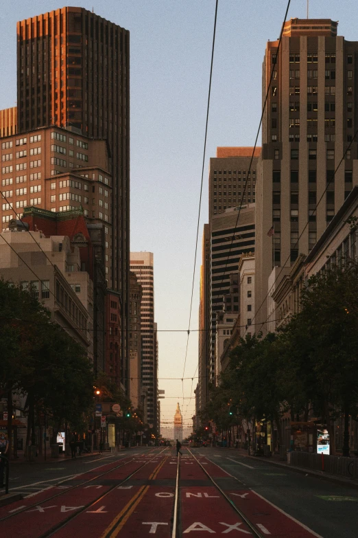 a very wide empty city street in the early evening