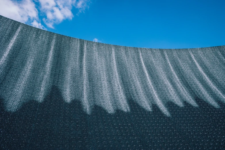 an unusual wall of white paint that is shaped to look like wavy and wavy lines