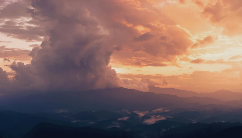 an incredible sunset is seen in the sky with the clouds coming down